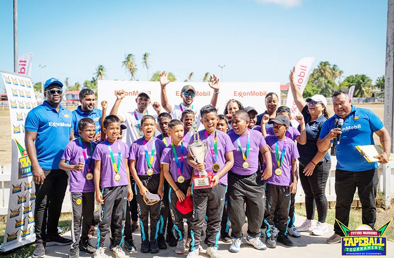 CHAMPIONS! Cropper Primary School celebrates their success along with officials from ExxonMobil Guyana and FL Sport