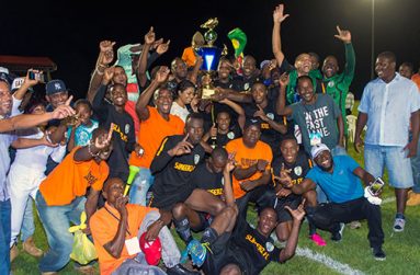 New football Kings of Guyana, Slingerz FC, and fans celebrate their 1-0 victory that dethroned Alpha United last Sunday night. (Samuel Maughn photo)