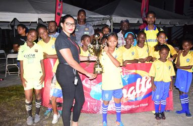 The West Ruimveldt Primary players pose with their winner’s trophy.