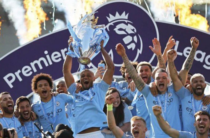 Manchester City's Vincent Kompany lifts the trophy as they celebrate winning the Premier League vs Brighton & Hove Albion at the American Express Community Stadium, Brighton, Britain - May 12, 2019 (REUTERS/Toby Melville)
