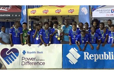 Champions Chase Academic Foundation  collects the League trophy from RBL Guyana Managing Director, Toussant Boyce