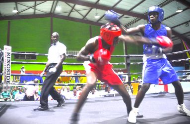 Guyana’s Chance Niles (right) and St Lucia’s Orlando Monrose traded punches before the Guyanese won on points on the opening night on Friday night (Sean Devers photos)