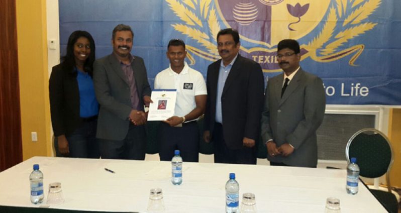 Head of Operations, Immanuel Prabalanathan, hands over the agreement to Shivnarine Chanderpaul. Also sharing the moment are Ashok Kumar, vice-president – International Operations, Anand Arulsamy Vice Chancellor and Sherry Ferrel.
