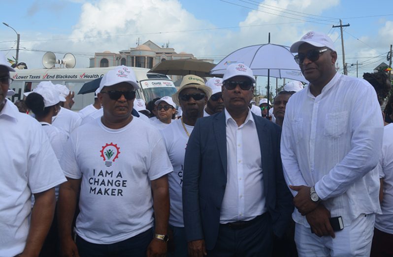 Change Guyana Presidential Candidate Robert Badal (centre), with the party’s Prime Ministerial Candidate Nigel Hinds and some of its supporters outside of the Umana Yana on Friday
