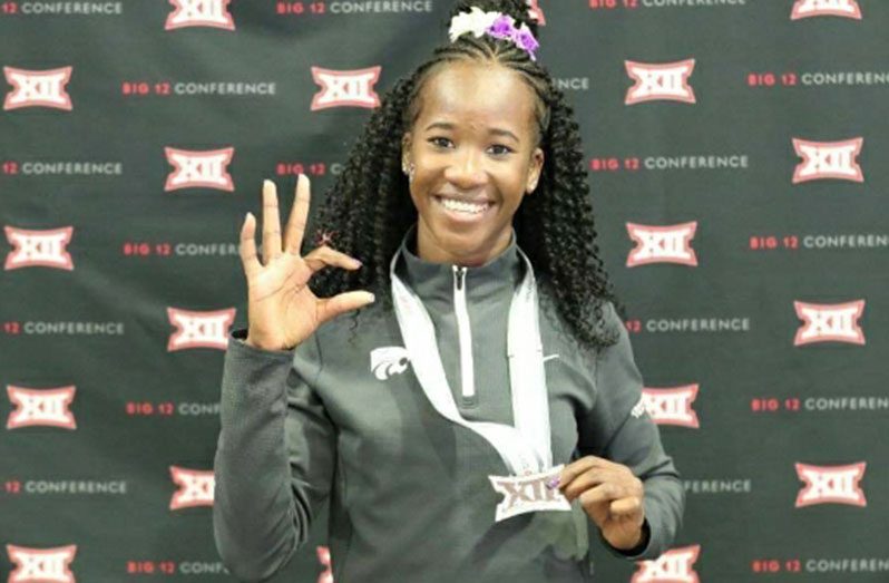 Chantoba Bright proudly shows off her second-place women’s long jump medal at the NCAA BIG 12 Indoor Championships.