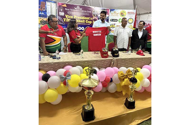 GSCL Secretary/Treasurer, Telesha Ousman hands over a specially designed tournament shirt to Minister Charles Ramson Jnr. Also in picture, from left, are GSCL Vice-president John Ramsingh, Lakhram Singh of Lakhram Singh Contracting Services and Dr, Jitender Singh of the Rajiv Gandhi University