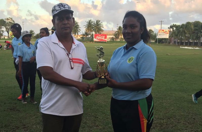 Player-of-the-match Cacey Charles collects her trophy from Chairman of the Guyana Cricket Board (GCB) junior selectors, Nazimul Drepaul.