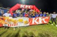 Chase Academy celebrating winning the KFC Goodwill Intl Sec School Football Championship trophy with KFC and Petra officials.