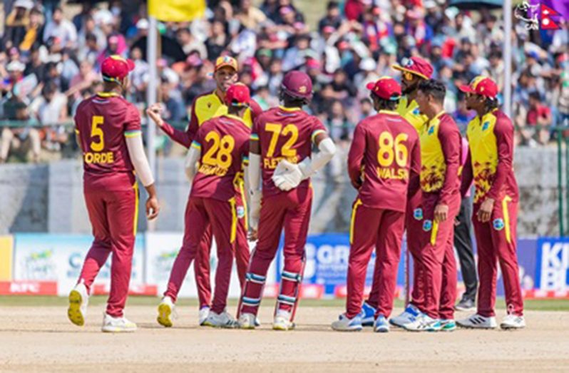 West Indies “A” captain Roston Chase (second from left) discusses strategy with his side during a break in play in the fourth Twenty20 against Nepal on Thursday. (CAN photo)