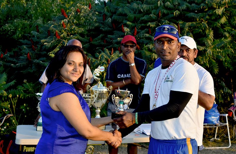 Berbice MVP Hemanrine Chattergoon collects his trophy from a member of the Khan family.