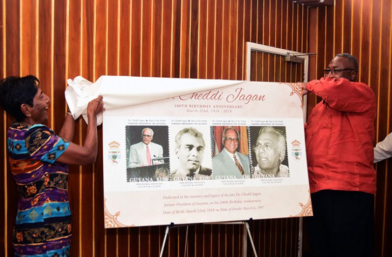 Sister of the late Dr. Cheddi Jagan Dr. Barbara Jagan and Chairman of Board of Directors of the GPOC Dr. Raphael Massiah unveil the commemorative stamps Wednesday (Adrian Narine photo)