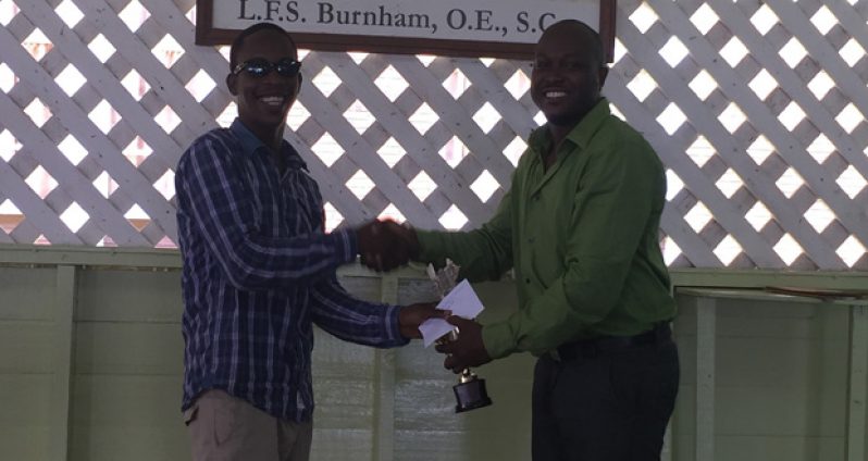 Wendell Meusa (left) receives his purse and trophy from sponsor Attorney-at-Law James Bond.