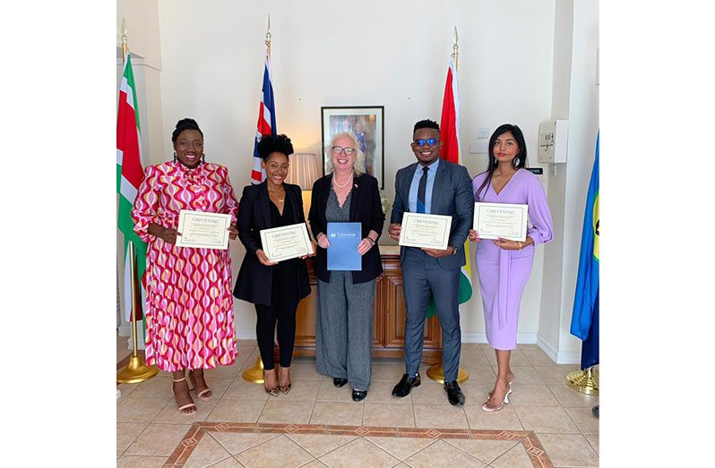 British High Commissioner to Guyana, Jane Miller (centre), flanked by the four recipients of the Chevening scholarship