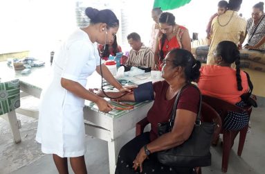 A nurse from the Suddie Public Hospital checking a patient’s blood pressure