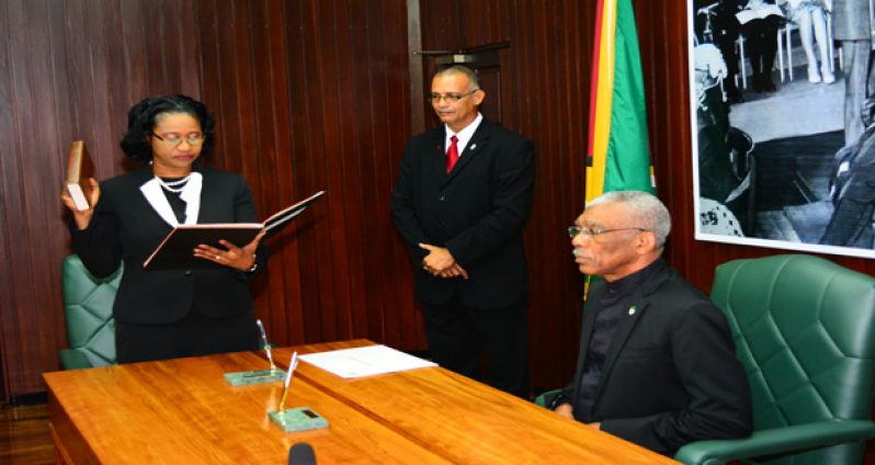 Justice Yonette Cummings-Edwards takes her oath of office before President David Granger on Wednesday at the Ministry of the Presidency.