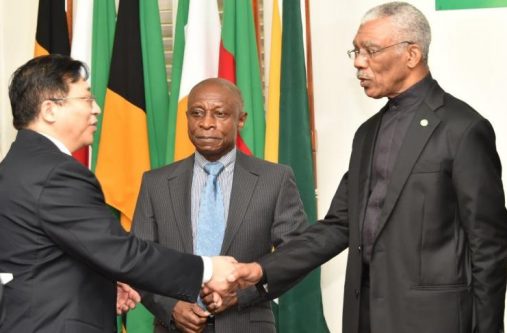 President David Granger and newly accredited Ambassador to Guyana, Mr. Cui Jianchun exchanges a handshake as acting Prime Minister and Minister of Foreign Affairs, Mr. Carl Greenidge looks on.