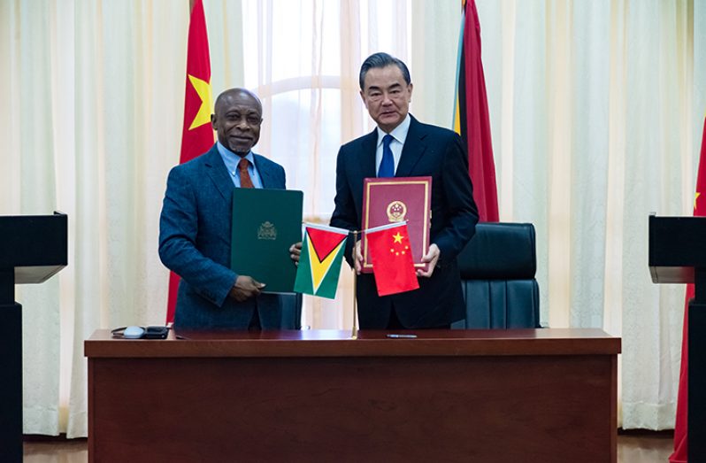 Minister of Foreign Affairs, Carl Greenidge, stands alongside State Councillor and Minister of Foreign Affairs of the People’s Republic of China, Wang Yi, shortly after signing an agreement last month at the Arthur Chung Convention Centre at Liliendaal.(Delano Williams photo)