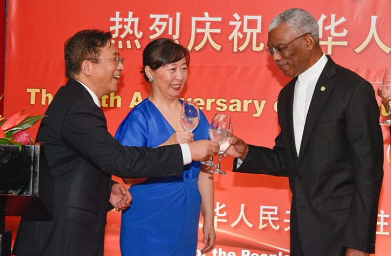 President David Granger sharing a toast with His Excellency Cui Jianchun, China's Ambassador to Guyana and Liang Huili