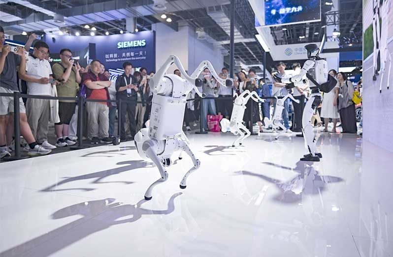 China Mobile's self-developed robot dogs and humanoid robot dance at the company's booth during the 2025 World AI Conference in East China's Shanghai, July 27, 2025 (Photo/Xinhua)