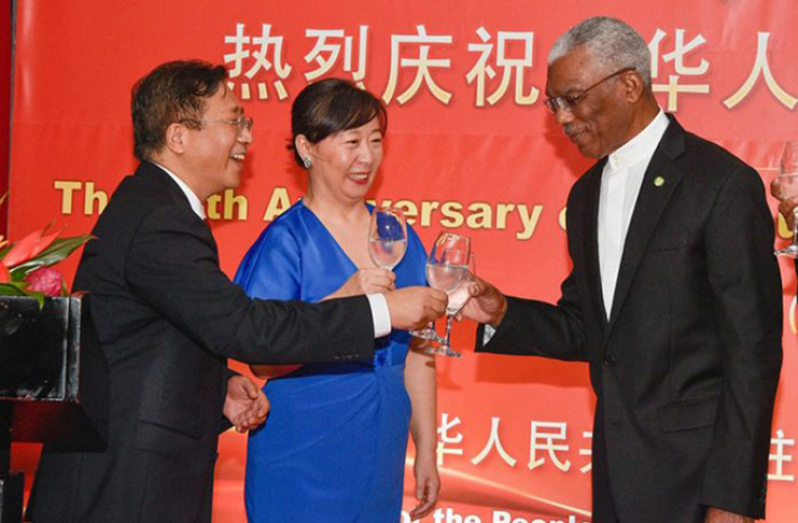 President David Granger sharing a toast with His Excellency Cui Jianchun, China's Ambassador to Guyana and Liang Huili at last year’s 70th Anniversary of the founding of the People’s Republic of China at the Arthur Chung Convention Centre