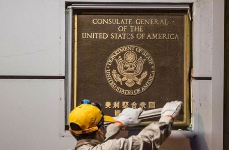 Workers began to remove the diplomatic plaque from the US consulate on Sunday (EPA)