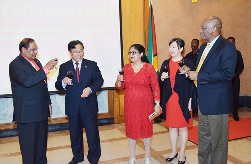 Prime Minister Moses Nagamootoo, shares a toast of renewed friendship with Chinese Ambassador Cui Juianchun and to usher in the Chinese Lunar New Year. Also in photo is wife of the ambassador Liang Huili, the Prime Minister’s wife Sita Nagamootoo and Minister of State Joseph Harmon