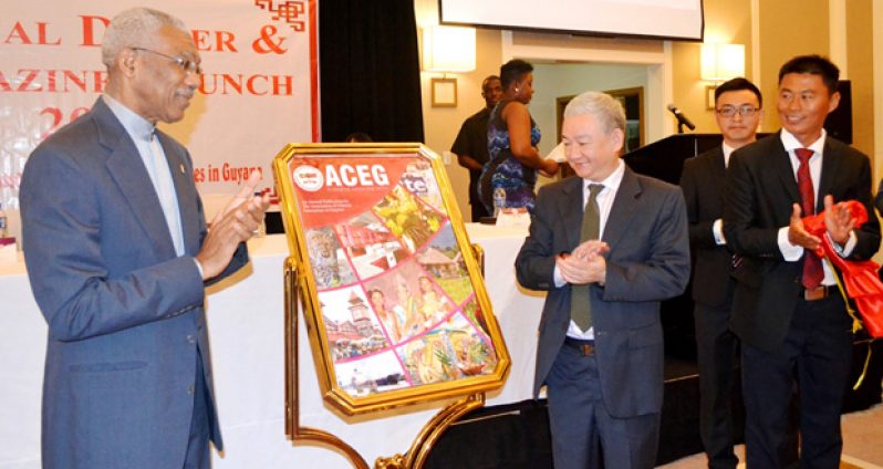 President David Granger, left, and Chinese Ambassador to Guyana, Zhang Limin, applaud after unveiling the 2016 Business Magazine of the Association of Chinese Enterprises in Guyana (ACEG)