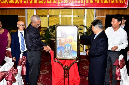 Chinese-2 President David Granger and Chinese Ambassador to Guyana, Cui Jianchun, unveil the Association of Chinese Enterprises in Guyana's 2017 Business Magazine
