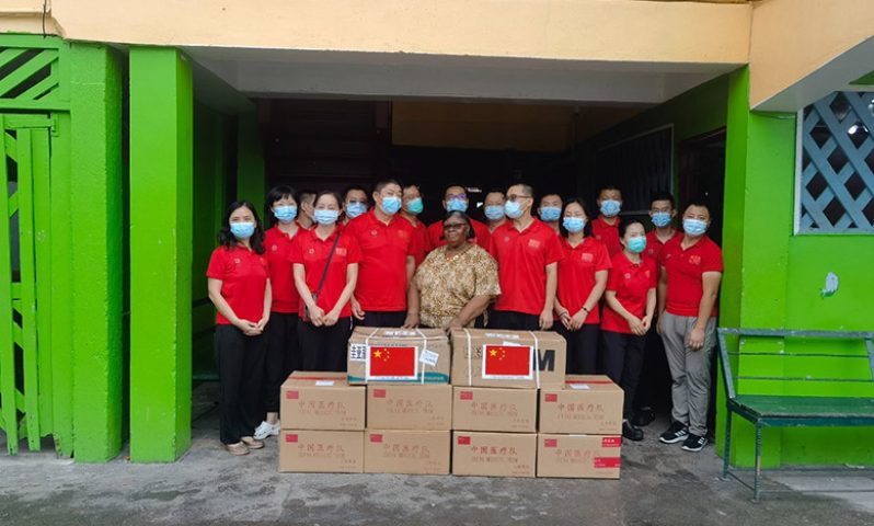 Representatives of the eighteenth Chinese Medical Brigade hands over some of the supplies to Gladys Accra, Manager/Administrator of Joshua House for Children