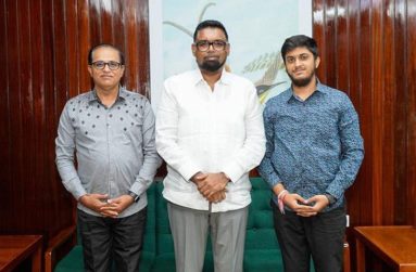 Guyana’s youngest accountant, Chirag Chandwani poses with President Irfaan Ali and his father, Devidas during a visit at Office of the President