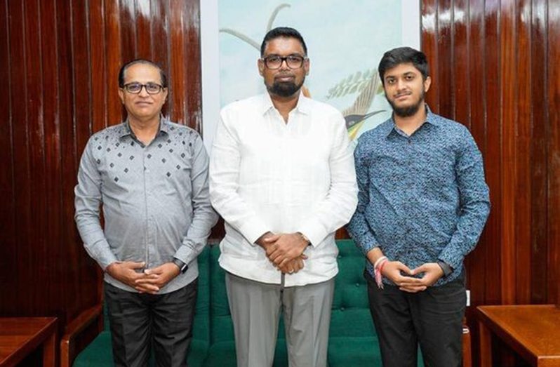 Guyana’s youngest accountant, Chirag Chandwani poses with President Irfaan Ali and his father, Devidas during a visit at Office of the President