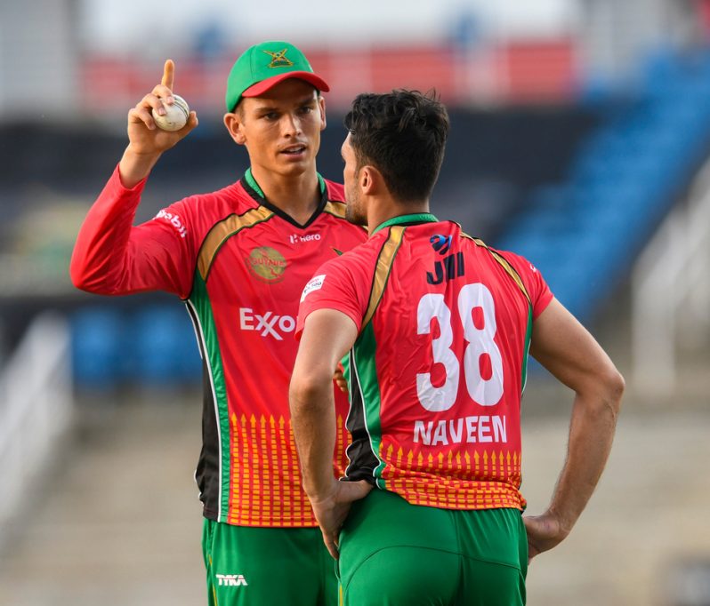 Chris Green (L) and Naveen ul Haq (R) of GAW talk during the Hero CPL match 8 against Jamaica Tallawahs at Brian Lara Cricket Academy on August 22, 2020 in Tarouba, Trinidad and Tobago. (Photo by Randy Brooks - CPL T20/CPL T20 via Getty Images)