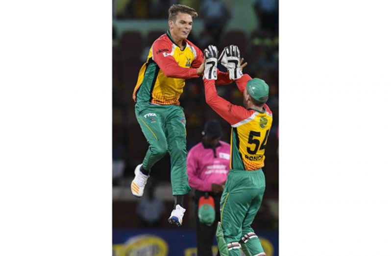 Guyana Amazon Warriors celebrate the dismissal of Evin Lewis of St Kitts & Nevis Patriots during the Hero CPL Match 2 between Guyana Amazon Warriors and St Kitts & Nevis Patriots at Guyana National Stadium on August 9, 2018 in Providence, Guyana. (Photo by Randy Brooks - CPL T20/Getty Images)