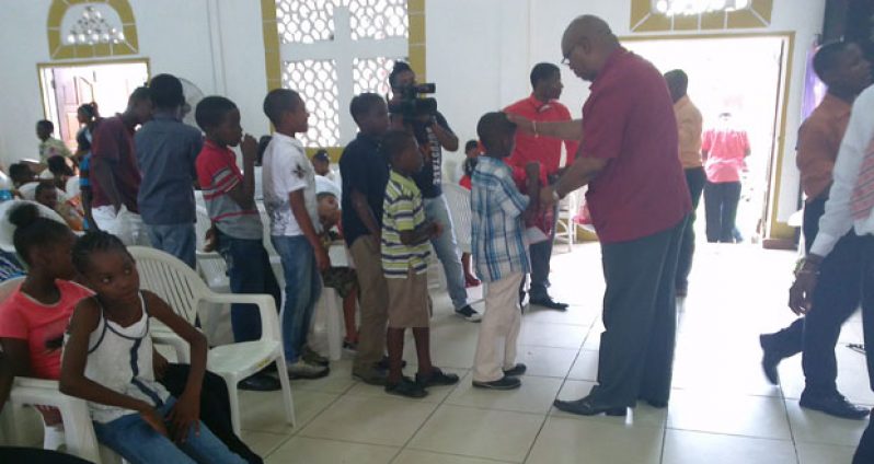 Bishop Juan Edghill distributing presents to youngsters