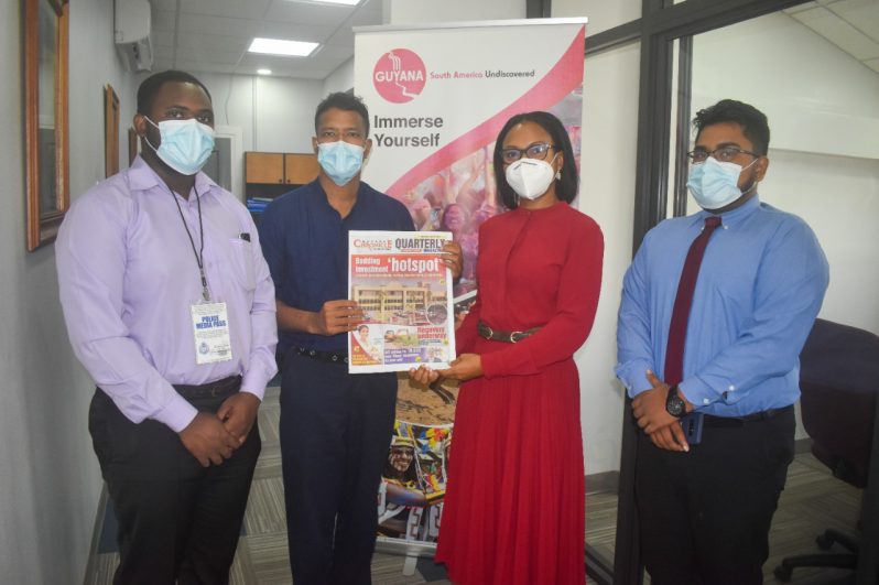 Minister of Tourism, Industry and Commerce, Oneidge Walrond, receives copies of the Chronicle Quarterly Magazine from Editor-in-Chief of the Guyana Chronicle, Tajeram Mohabir. Also in the photo are Assistant Editor at the Guyana Chronicle, Navendra Seoraj, and Reporter Jared Liddell