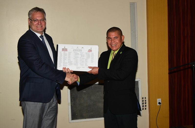 Ambassador of the European Union Delegation, Jernej Videti? presenting Minister of Social Cohesion, Culture, Youth and Sport, Dr. George Norton with a copy of the Comprehensive Restoration and Sustainable Conservation Management Plan.