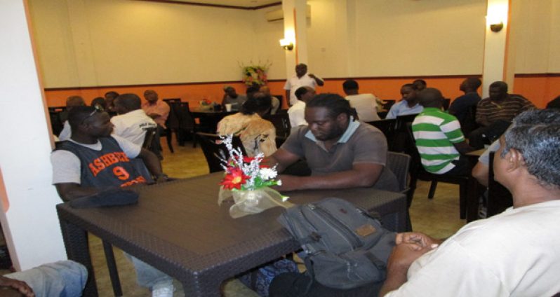 Town Clerk Royston King addresses drainage employees during the meeting