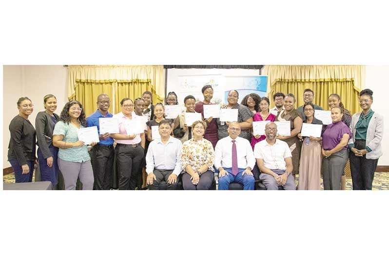 Seated third from left: Minister of Health, Dr Frank Anthony; Chief Medical Officer flanked by Dr Narine Singh; Government Medical Officer of Health, Dr Quacy Grant, Head of CR-FELTP, CARPHA, Dr Laura-Lee Boodram with the graduating batch