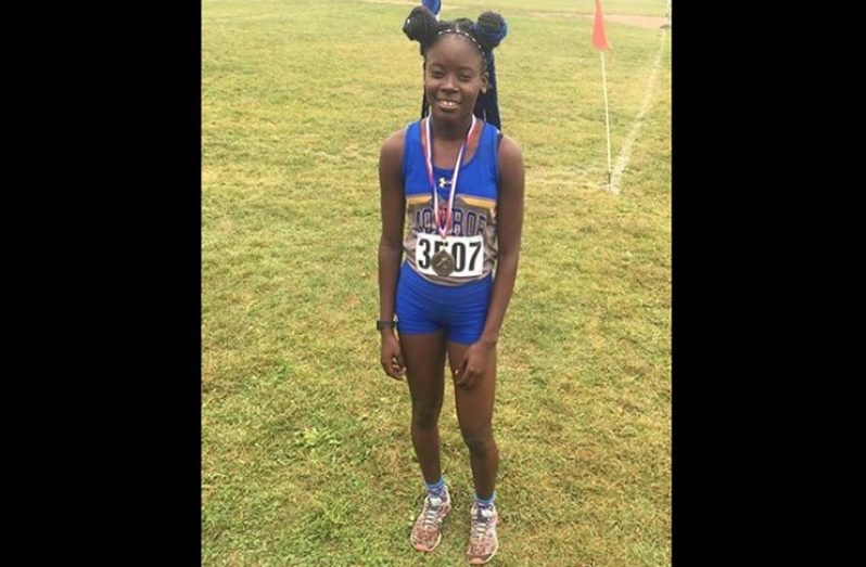 Guyana’s Claudrice McKoy shows off her medal after her cross-country win last Sunday (photo credit: Monroe College)
