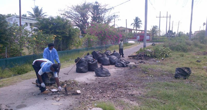 Members of the St. Teresa’s Roman Catholic Church pile up bags of garbage