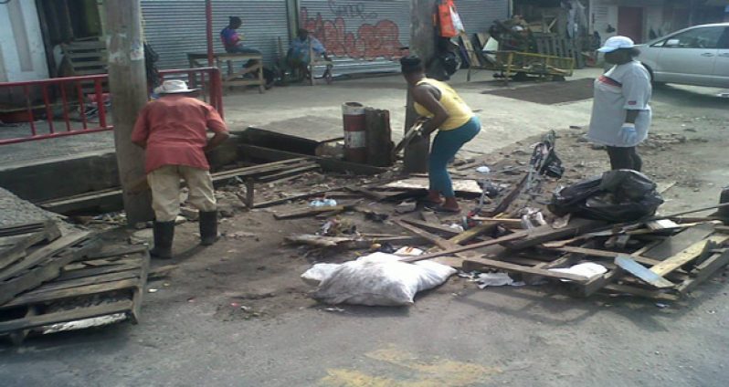 An illegal dumpsite being removed by the solid waste team