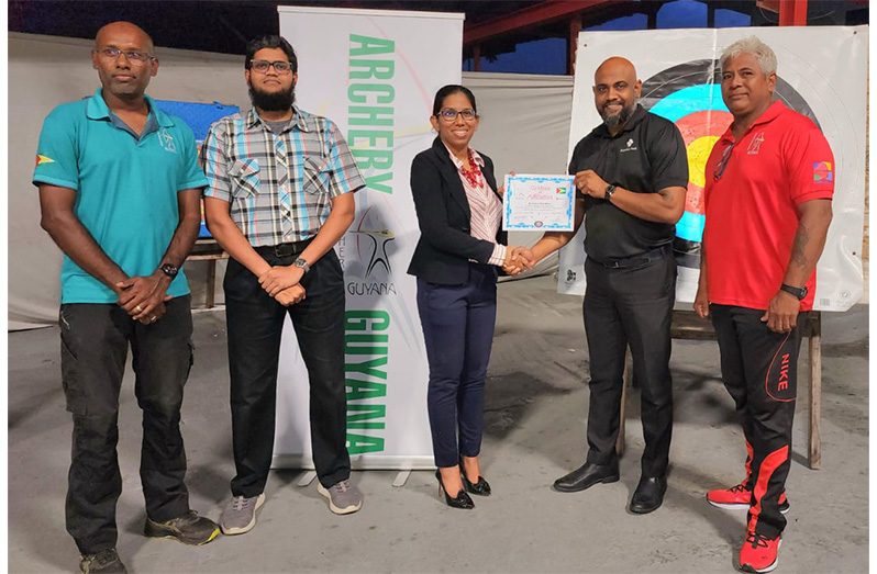 In photo from left to right: Mr. Ryan McKinnon, Mr. Saeed Karim and Mrs. Vidushi Persaud-McKinnon from Archery Guyana handing over Certificate of Affiliation to President of Archers Paradise, Mr. Ganesh Somrah. On far right is Vice-President Mr. Kenrick Cheeks of Archers Paradise.