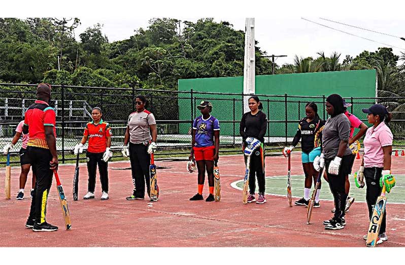 Coach Rawle Merrel takes the ladies through their drills last Saturday on the Basketball Court of the National Gymnasium