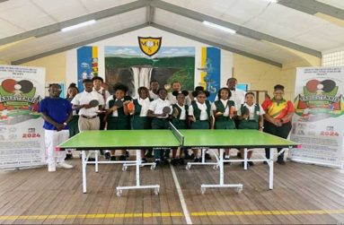 Coordinators ITTF Coach Marlon Washington (far left) Coach Candacy Mc Kenzie (far Right) with some of the Players at the McKenzie High School auditorium