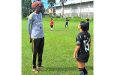 Coach Troy Wright discussing tactics with Ella Fernandes at the YMCA Ground