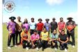 Nidia Andrews (second from left) with the ladies and
coaches at the Anna Regina ground on Sunday.