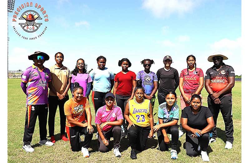 Nidia Andrews (second from left) with the ladies and
coaches at the Anna Regina ground on Sunday.