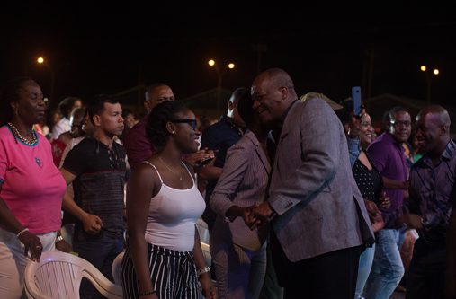 Minister of State, Joseph Harmon (right), taking time to meet with some of the concert goers (Delano Williams photo)