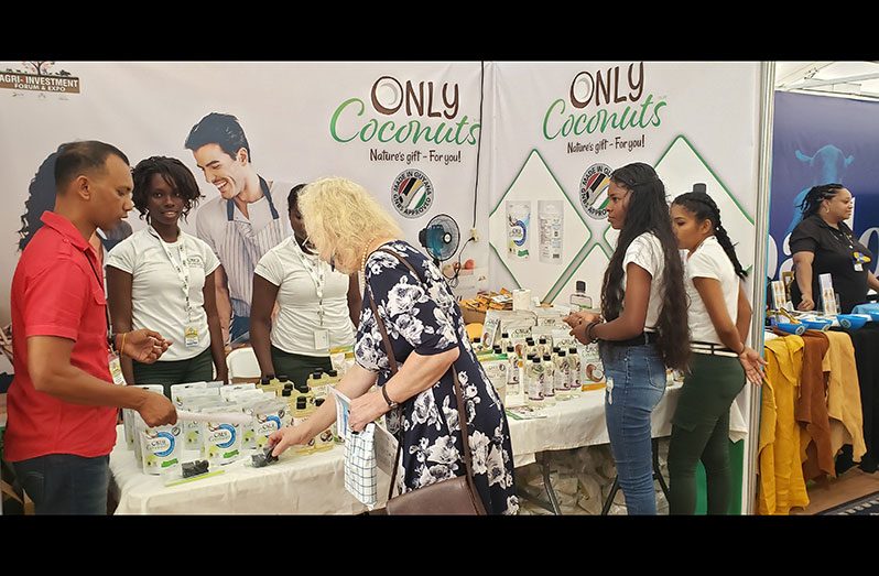At left, Vice President of Precision Global Inc. (Only Coconuts), Lesley Ramlall, interacts with British High Commissioner to Guyana, Jane Miller, on the benefits of the company’s products on display at the recent Agriculture Investment Forum and Expo (Rabindra Rooplall photo)