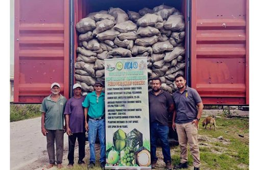 Third from left: Mr. Ricky Roopchand, the General Manager of Hope Coconut Estate, along with Adrian Mangar, Scientist at NAREI (second from right), and other representatives from NAREI, with one of the containers containing Philippine Green Dwarf Variety coconut seed nuts